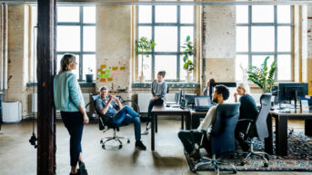 a group of people sitting around a table in an office