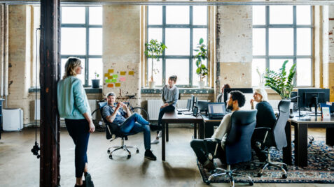 a group of people sitting around a table in an office