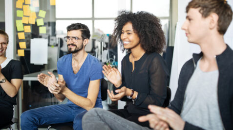 a group of people sitting around each other