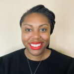 a woman wearing a black shirt and red lipstick