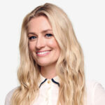 a woman with long blonde hair wearing a white shirt