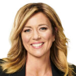 a woman with blonde hair smiling at the camera