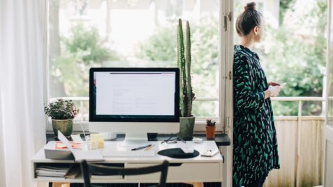 a woman standing in front of a computer