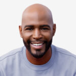 a man with a bald head wearing a blue shirt