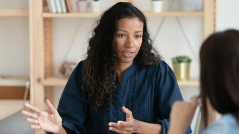 a woman talking to someone in front of her
