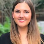 a woman with long brown hair wearing a black shirt