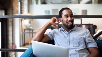 a man sitting in front of a laptop computer