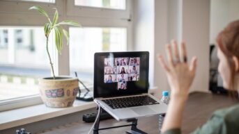a laptop computer sitting on top of a wooden table