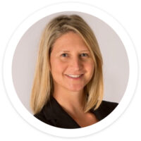 a woman with blonde hair is smiling for the camera