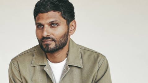 a man with a beard is looking at the camera