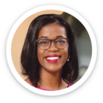 a woman wearing glasses and smiling for the camera