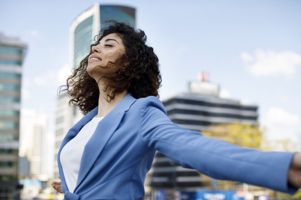 a woman in a blue jacket is smiling