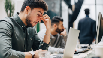 a man sitting in front of a laptop computer