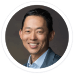 a man in a suit smiling for a picture