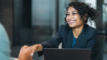 HR professional shaking hands with person in office