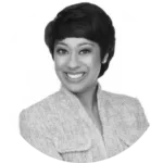 a black and white photo of a smiling woman