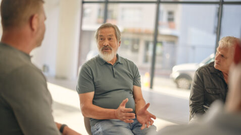 a group of veterans sitting around a table talking