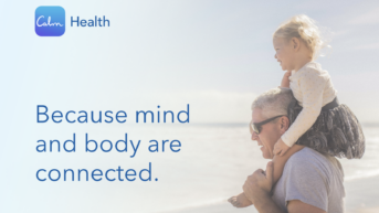 a man carrying a little girl on his shoulders