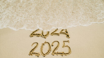 the date written in the sand on the beach