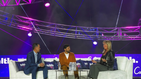 a group of people sitting on top of a white couch