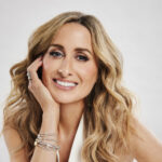 a woman sitting at a table with her hand on her face