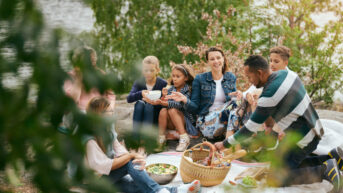 a group of people sitting around a picnic