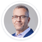 a man wearing glasses and a blue jacket