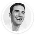 a black and white photo of a smiling man