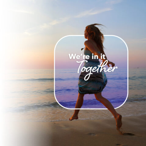 a girl running on the beach with the words we're in it together