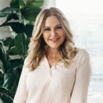 a woman standing in front of a window