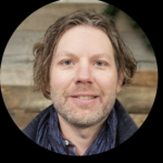 a man with a beard and a blue shirt