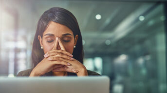 Woman executive feeling stress at her computer