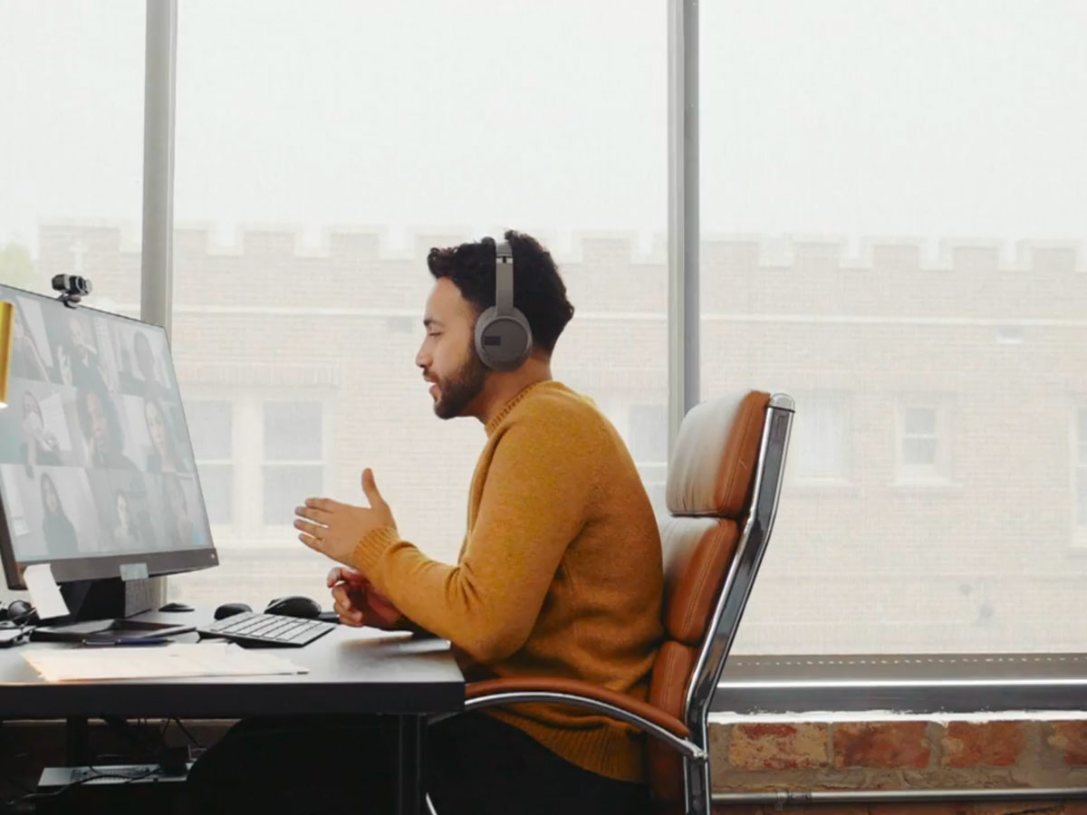 Businessman updates colleagues during virtual meeting fallback image