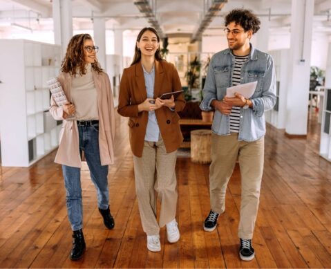 a group of people walking down a wooden floor