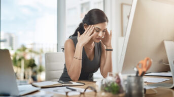 a woman sitting at a desk in front of a computer