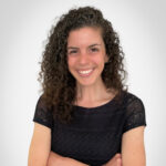 a woman with her arms crossed posing for a picture