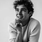 a black and white photo of a smiling man